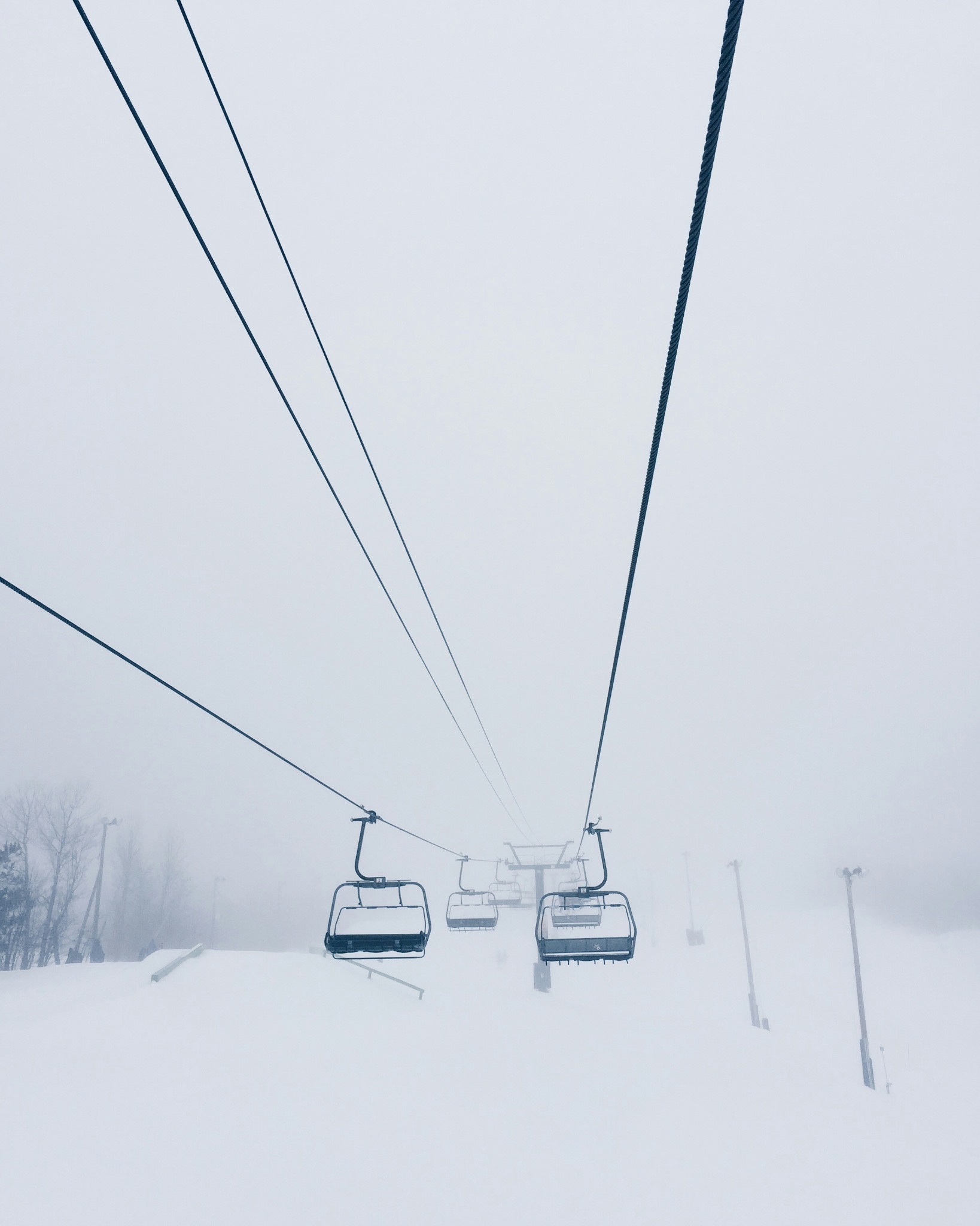 Chairlift in alpine fog